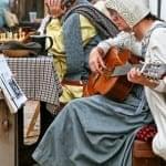 woman playing guitar in old peasants clothes