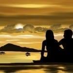 couple sitting in front of sunsett