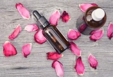 essential oil, massage oil, and rose petals