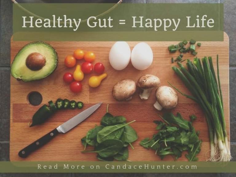 cutting board with vegetables, eggs, and a knife caption "Healthy Gut = Happy Life)