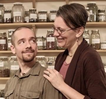 Katja and Ryn from Commonwealth Center for Holistic Herbalism with shelves of herbs