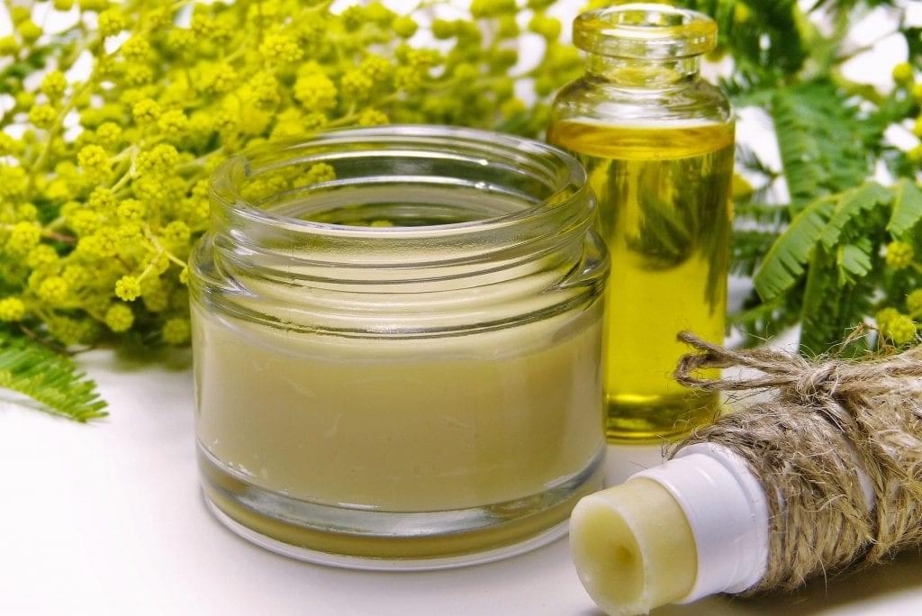 lip balm and cream near flowers